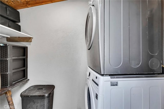 laundry area featuring stacked washer / drying machine