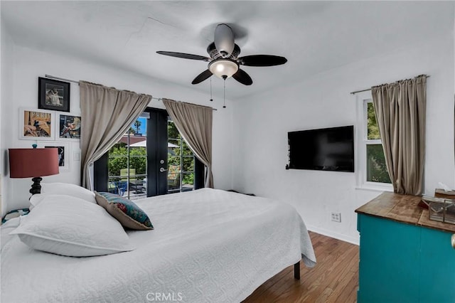 bedroom with wood finished floors, baseboards, access to exterior, and a ceiling fan