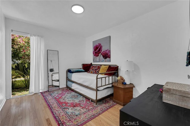 bedroom featuring hardwood / wood-style flooring and baseboards