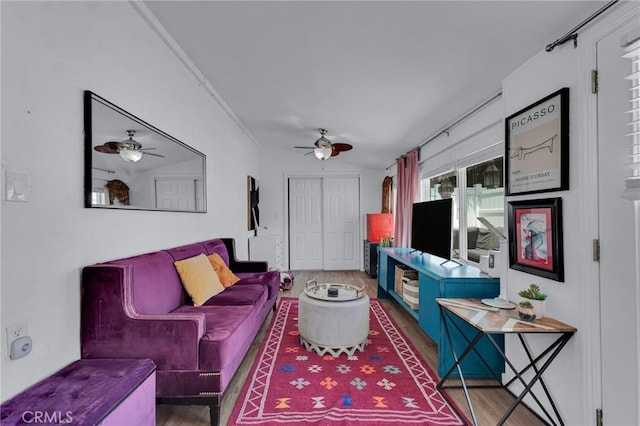living area featuring a ceiling fan and wood finished floors