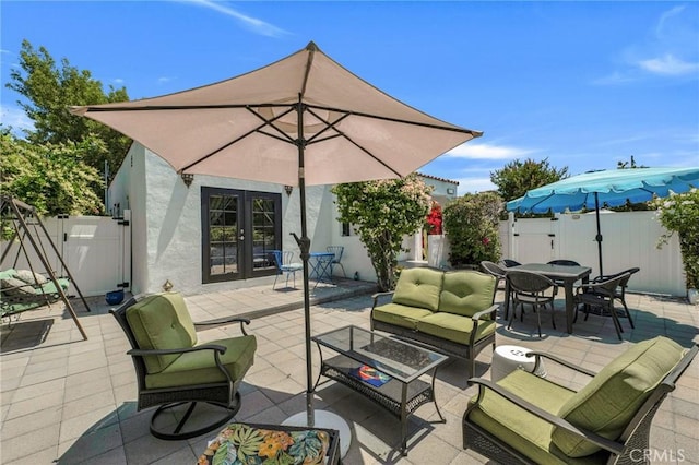 view of patio / terrace featuring french doors, a fenced backyard, an outdoor hangout area, and outdoor dining area
