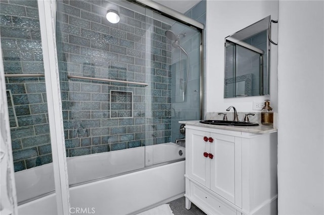 full bathroom featuring bath / shower combo with glass door and vanity