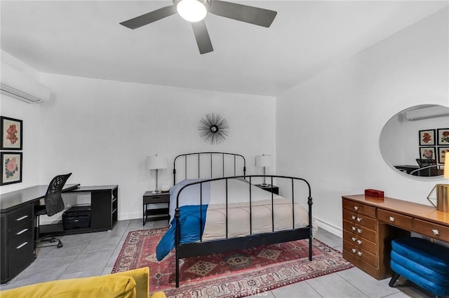 bedroom with an office area, a wall mounted AC, and tile patterned flooring