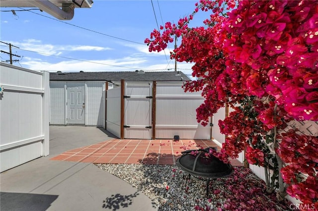 view of outbuilding with a gate and fence