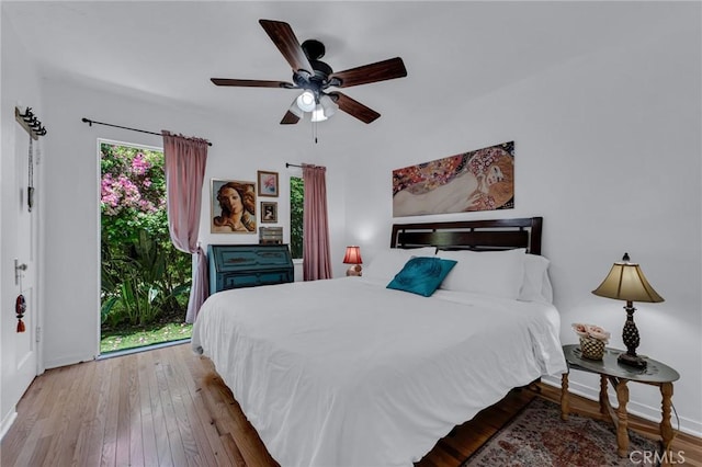 bedroom with baseboards, wood finished floors, and ceiling fan