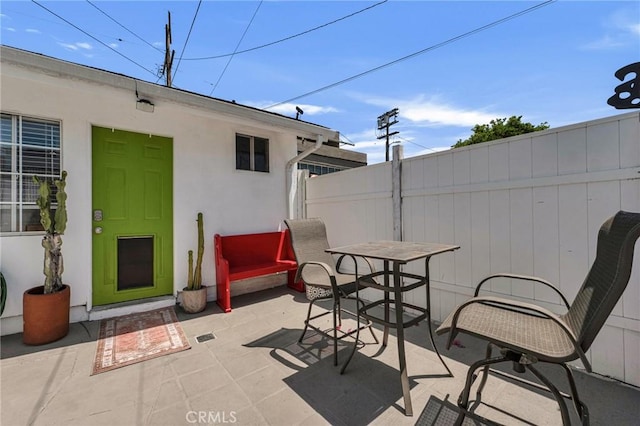 view of patio featuring fence