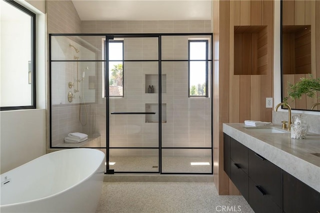 full bath with a shower stall, a soaking tub, and healthy amount of natural light