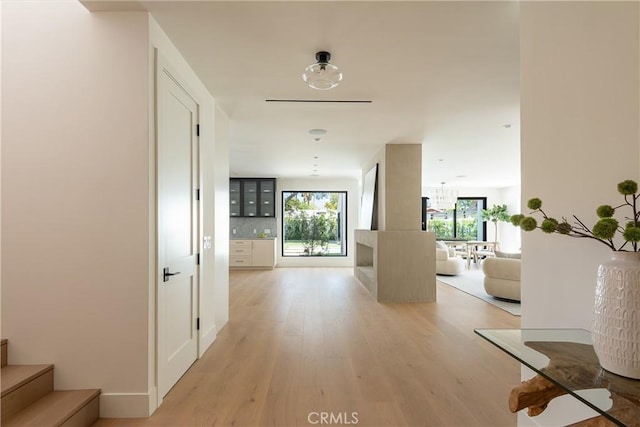 hall featuring light wood-style flooring and stairs