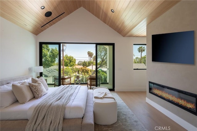 bedroom with wood finished floors, a glass covered fireplace, lofted ceiling, wooden ceiling, and baseboards