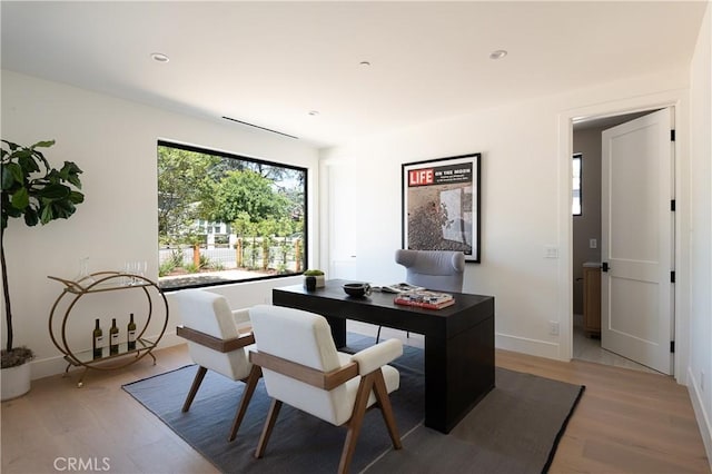 home office with light wood finished floors, baseboards, and recessed lighting