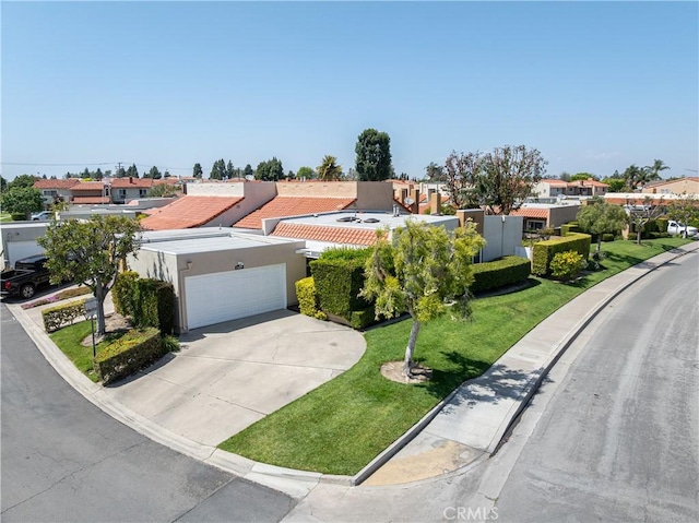 view of front of home with a garage, a residential view, stucco siding, concrete driveway, and a front lawn