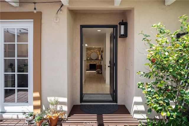 entrance to property featuring stucco siding