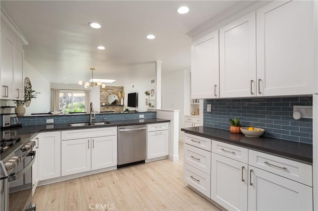 kitchen featuring a sink, stainless steel appliances, tasteful backsplash, a chandelier, and recessed lighting