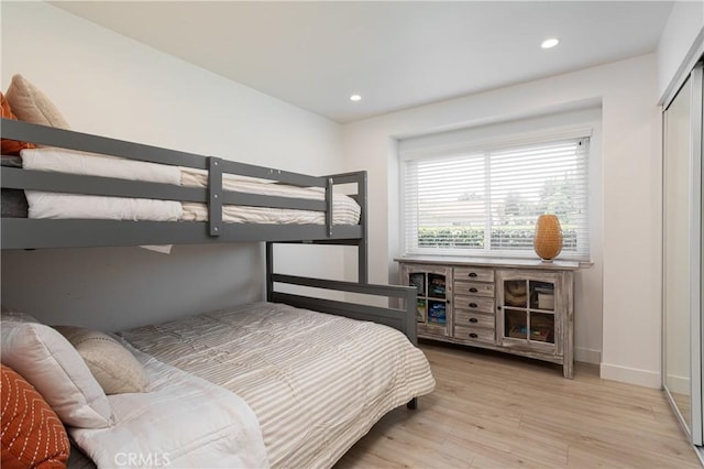 bedroom featuring wood finished floors, baseboards, and recessed lighting