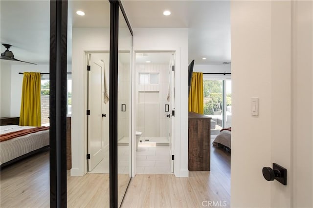 hallway with light wood-style flooring and recessed lighting