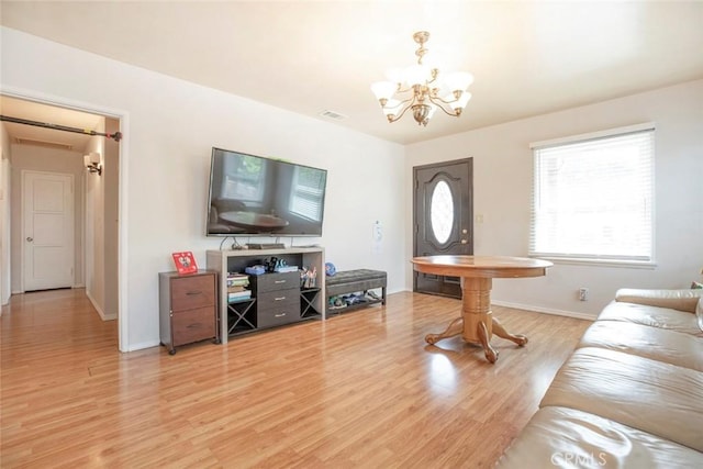 1821 N Niagara St, Burbank, CA 91505 - living room featuring a chandelier, light wood-type flooring, and baseboards