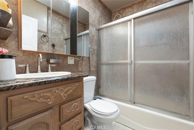 1821 N Niagara St, Burbank, CA 91505 - bathroom with backsplash, vanity, toilet, bath / shower combo with glass door, and tile walls