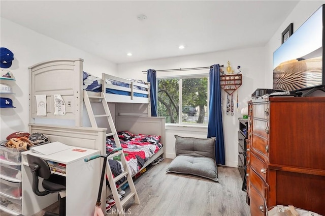 bedroom with wood finished floors and recessed lighting