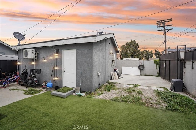 outdoor structure at dusk with a cooling unit