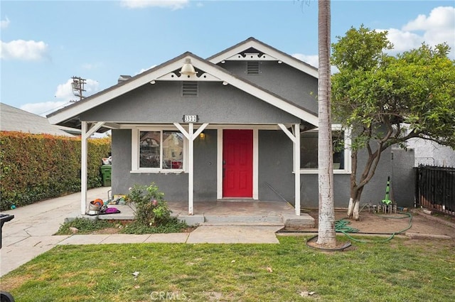 view of front of house with stucco siding and a porch