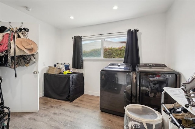 laundry room featuring washer and dryer, light wood-style floors, baseboards, and recessed lighting