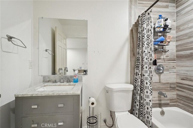 bathroom with toilet, vanity, and shower / tub combo with curtain