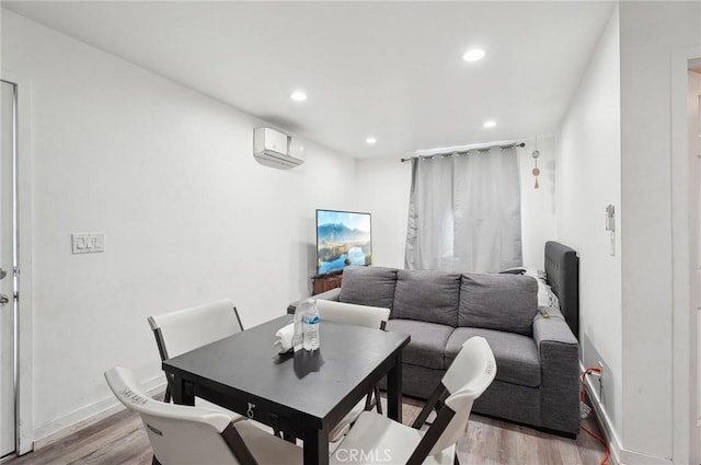 dining area featuring light wood-style flooring, recessed lighting, baseboards, and an AC wall unit