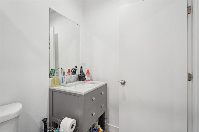 half bathroom with toilet and vanity