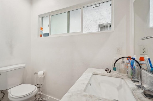 half bath featuring toilet and vanity