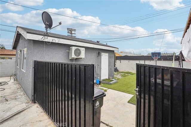 garage with fence and ac unit