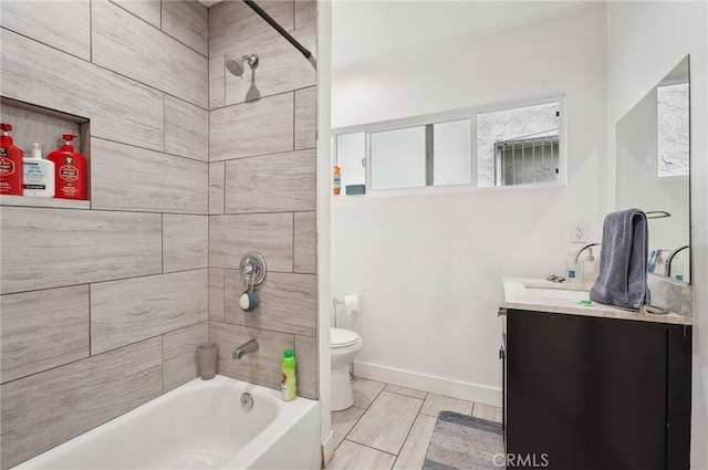 full bath featuring toilet, vanity, tub / shower combination, and baseboards