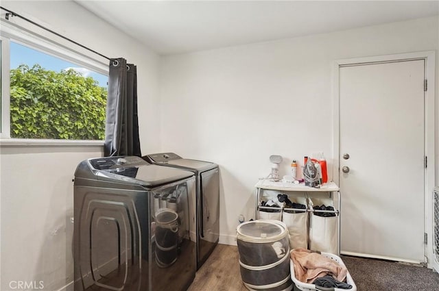washroom featuring washing machine and clothes dryer and wood finished floors