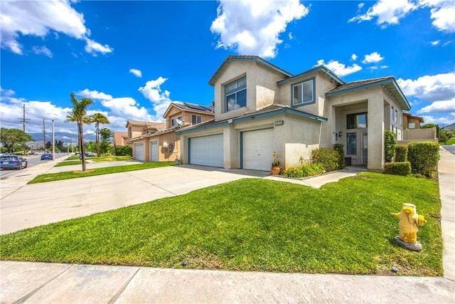 view of front of property featuring stucco siding, a garage, driveway, and a front yard