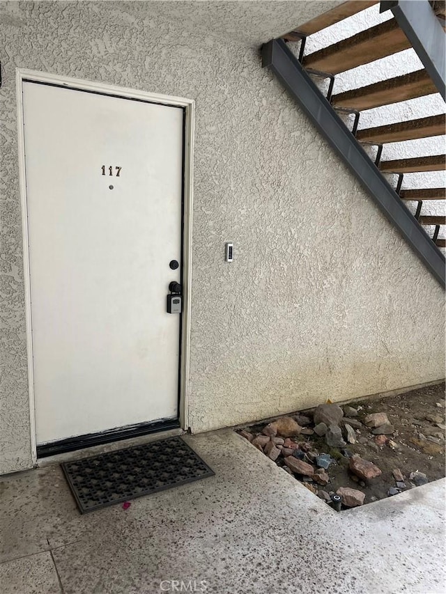 property entrance featuring stucco siding