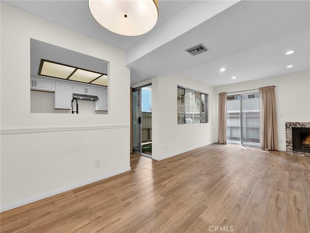 20155 Keswick St Unit 117, Winnetka, CA 91306 - unfurnished living room featuring light wood-type flooring, baseboards, a fireplace, and recessed lighting