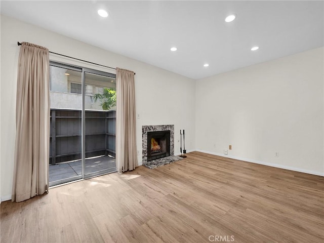 20155 Keswick St Unit 117, Winnetka, CA 91306 - unfurnished living room with wood finished floors, a fireplace, and recessed lighting