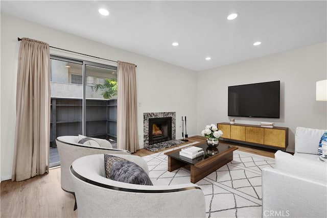 20155 Keswick St Unit 117, Winnetka, CA 91306 - living room featuring wood finished floors, recessed lighting, and a high end fireplace