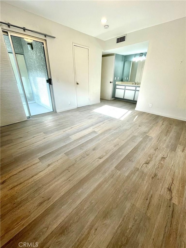 20155 Keswick St Unit 117, Winnetka, CA 91306 - unfurnished bedroom with wood finished floors and access to exterior