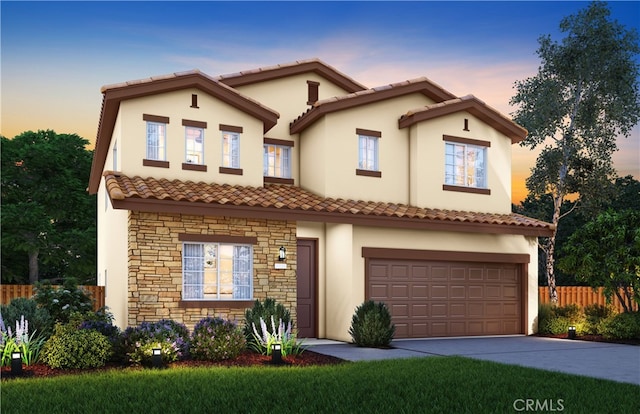 2038 Casey Ln, Los Banos, CA 93635 - mediterranean / spanish-style home with stone siding, a tile roof, stucco siding, an attached garage, and concrete driveway