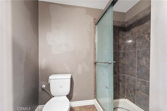 576 Rose Ln, Twin Peaks, CA 92391 - full bathroom with a stall shower, toilet, tile patterned flooring, and baseboards