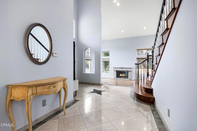 1985 Erin Way, Glendale, CA 91206 - foyer with baseboards, a towering ceiling, a glass covered fireplace, stairway, and granite floors