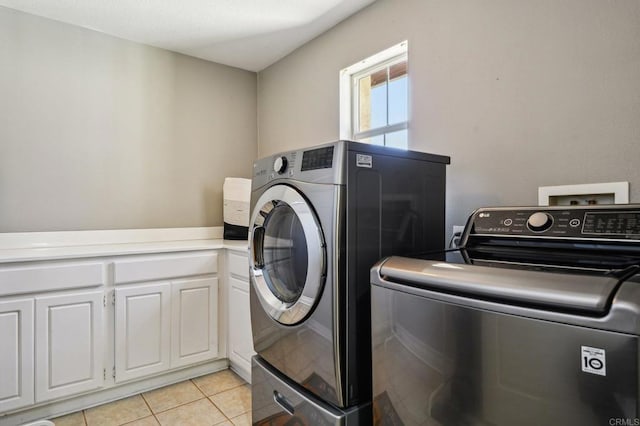 32555 Safflower St, Winchester, CA 92596 - washroom featuring independent washer and dryer, light tile patterned floors, and cabinet space