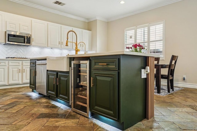 32555 Safflower St, Winchester, CA 92596 - kitchen featuring wine cooler, stainless steel appliances, stone tile floors, decorative backsplash, and white cabinets