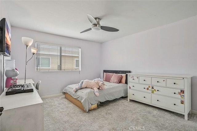 bedroom with light colored carpet, a ceiling fan, and baseboards