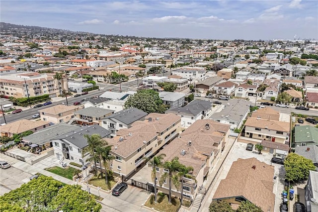aerial view of property and surrounding area featuring nearby suburban area