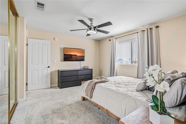 carpeted bedroom with baseboards and a ceiling fan