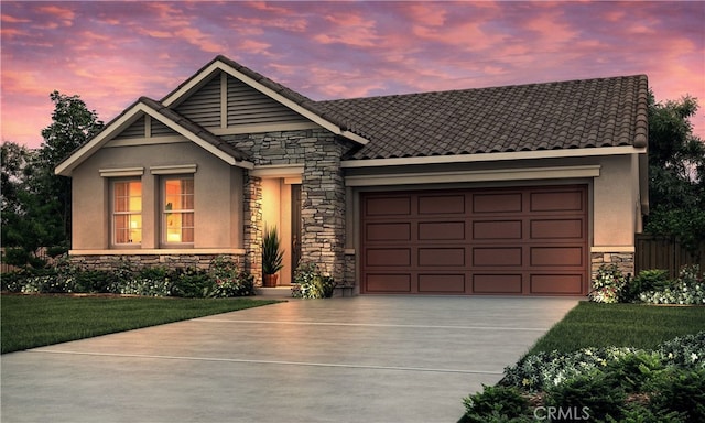 2054 Casey Ln, Los Banos, CA 93635 - view of front of home with stone siding, driveway, a garage, and stucco siding