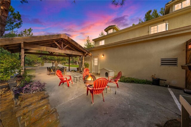 41225 Hacienda Dr, Murrieta, CA 92562 - patio terrace at dusk featuring a gazebo and an outdoor fire pit