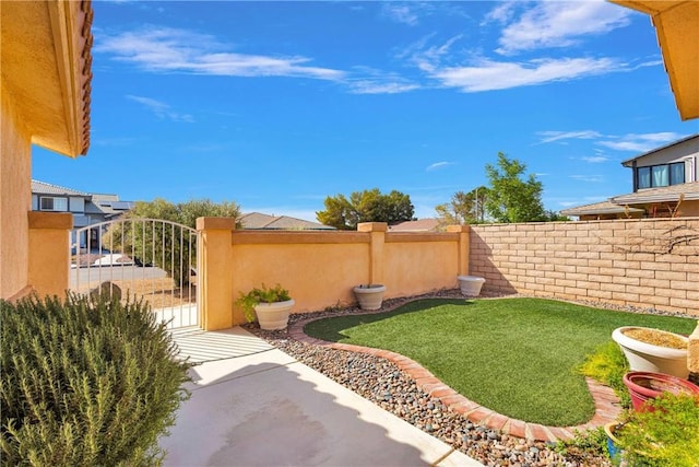 view of yard with fence and a gate