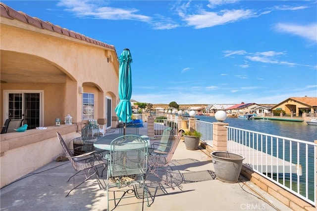 view of patio / terrace with a water view and outdoor dining space